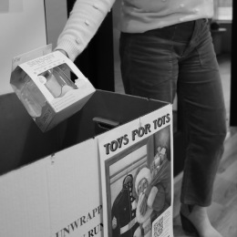 a person holding a toy over a box