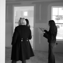 three women standing in an empty building