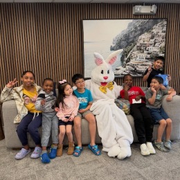 a group of people sitting with an easter bunny
