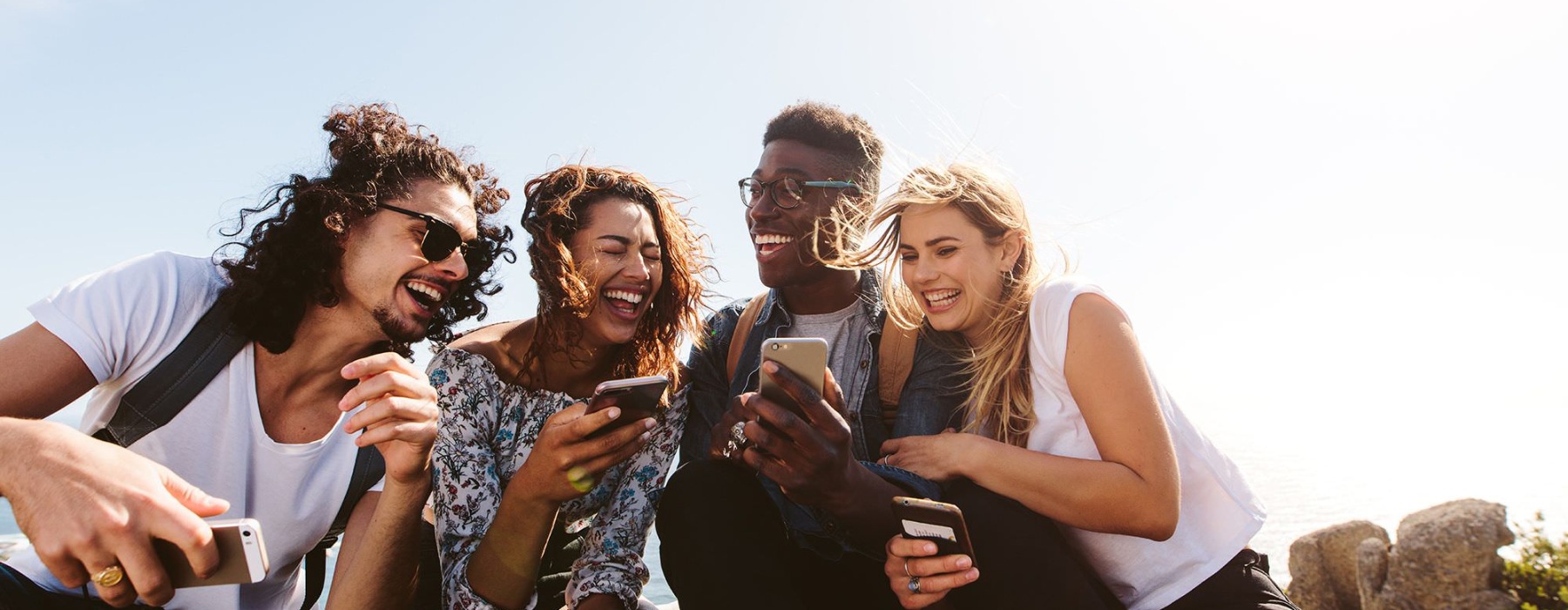 a group of people laughing at a phone